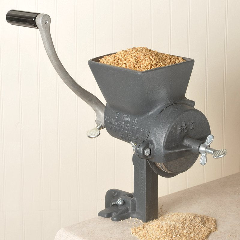 Handcrafted Quaker City grain mill made in USA, featuring a large hopper filled with grain, sturdy cast iron body, and a manual crank for adjustable coarse to fine grinding, ideal for kitchen, bread making, and grain mill collections.