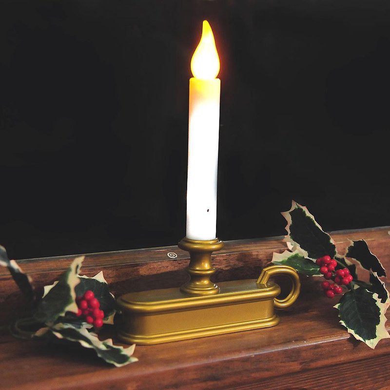 Handcrafted cordless window candle with a warm LED flicker light in a gold holder, accented by festive holly leaves and berries, ideal for Home & Decor and Holiday Decor collections.