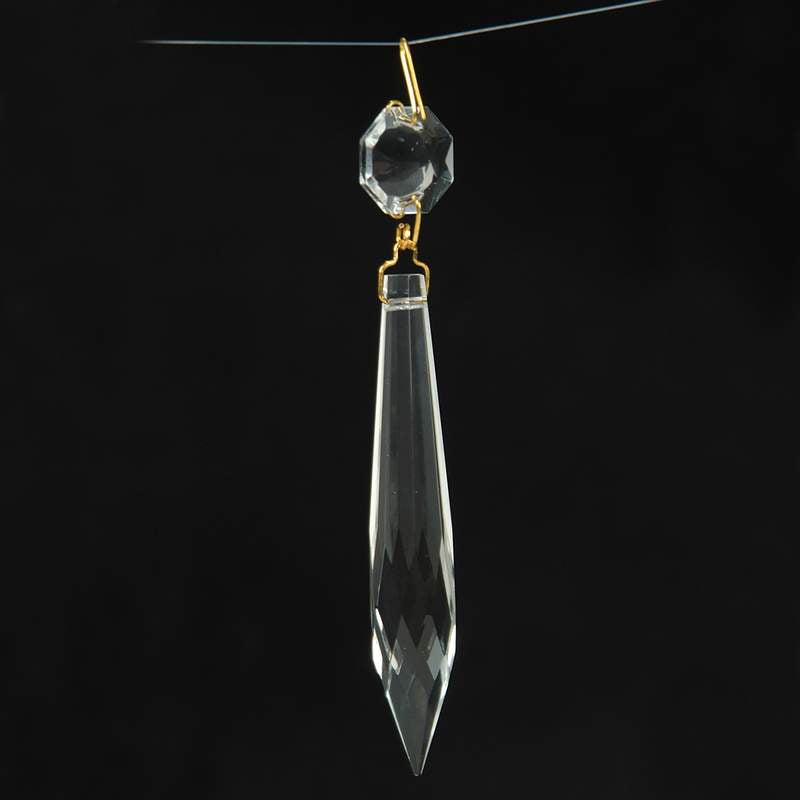 Clear glass pendant prism with faceted octagon and elongated teardrop shapes, featuring a polished brass pin, ideal for lamps and lighting accessories and best sellers collection.