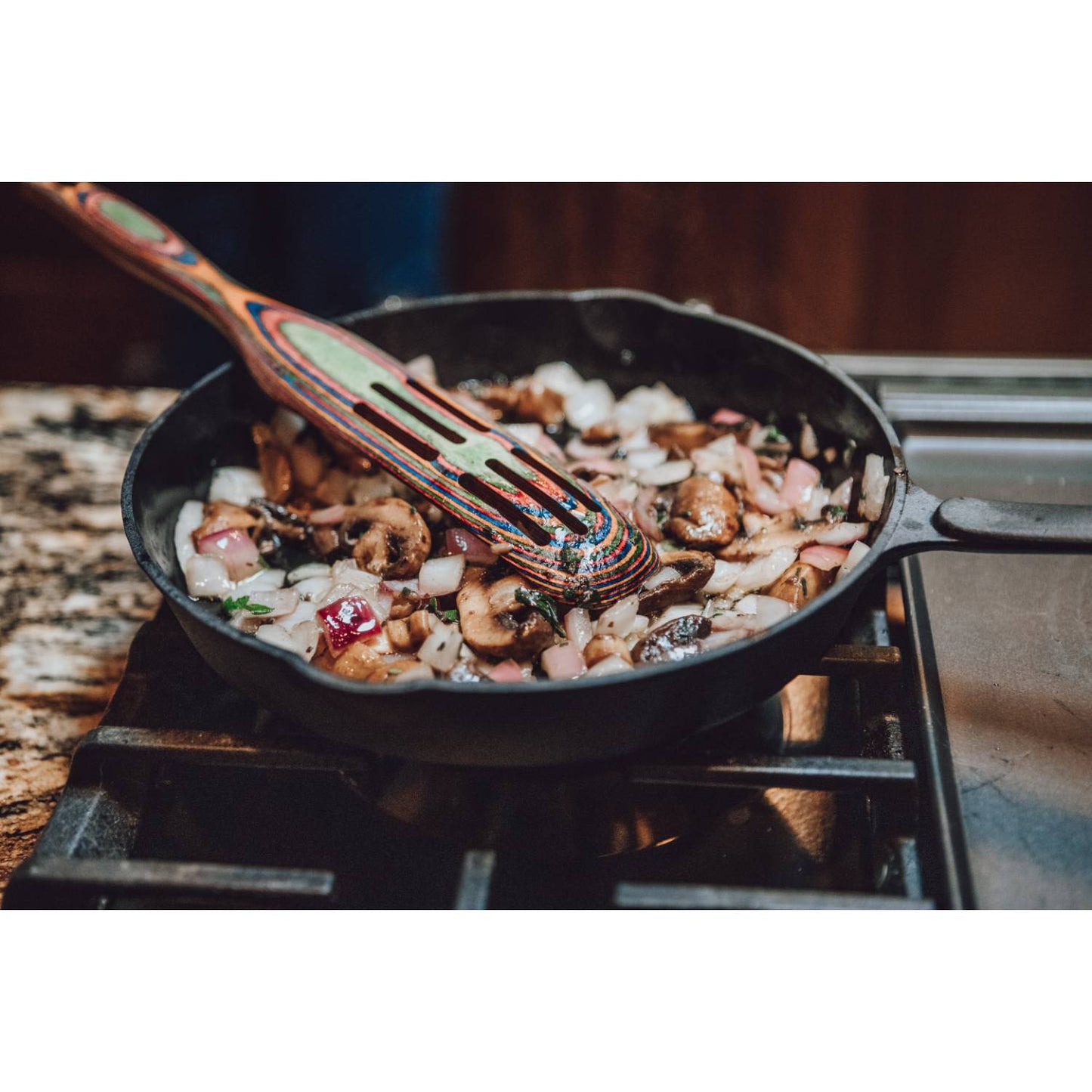 Handcrafted nitrogen-hardened cast iron skillet cooking sautéed mushrooms and onions on stovetop with a smooth, stick-resistant surface, ideal for Kitchen & Food, Cookware, Cast Iron, Best Sellers, and Promo Eligible collections.