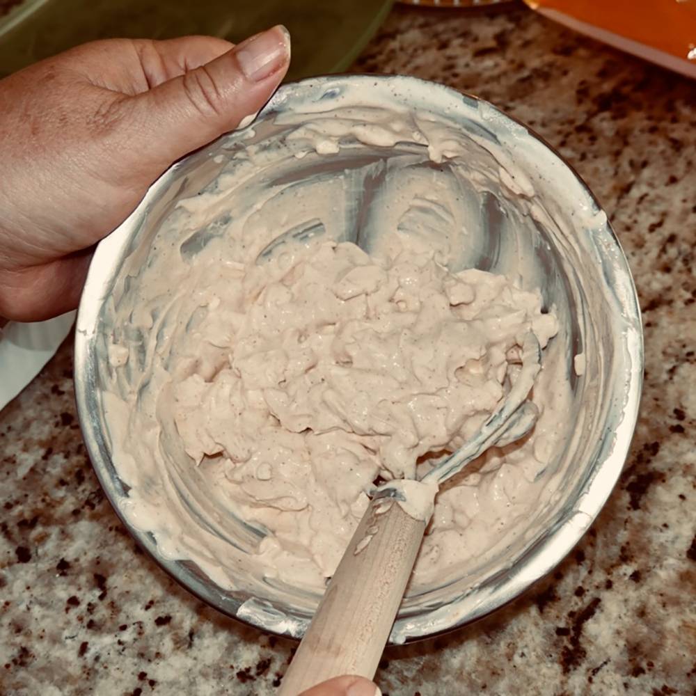 Handcrafted Old Country dough whisk with a smooth natural wood handle stirring thick dough in a metal bowl, perfect for Kitchen & Food, Baking Supplies, and Amish Made collections.