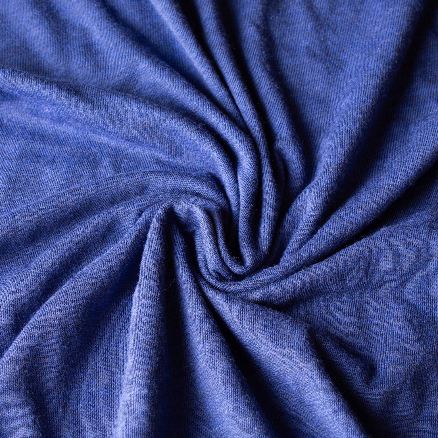 Close-up of soft blue fabric with a smooth texture, showcasing lightweight and comfortable material ideal for health and wellness, emergency supplies, and clothing collections.
