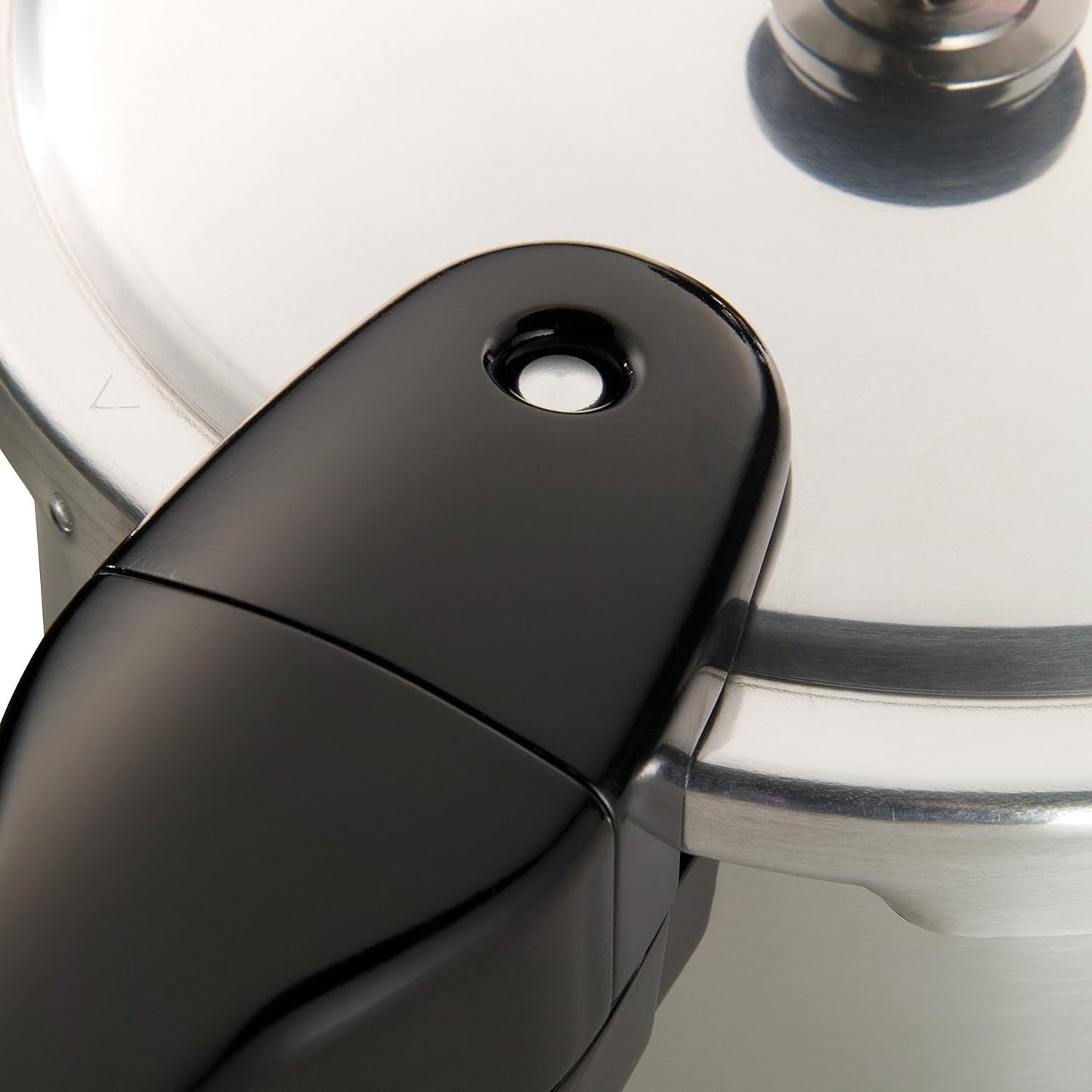 Close-up of a polished aluminum pressure cooker lid with a smooth black ergonomic handle, showcasing quality craftsmanship, featured in Kitchen & Food, Cookware, Pots and Pans, Best Sellers, Promo Eligible collections.