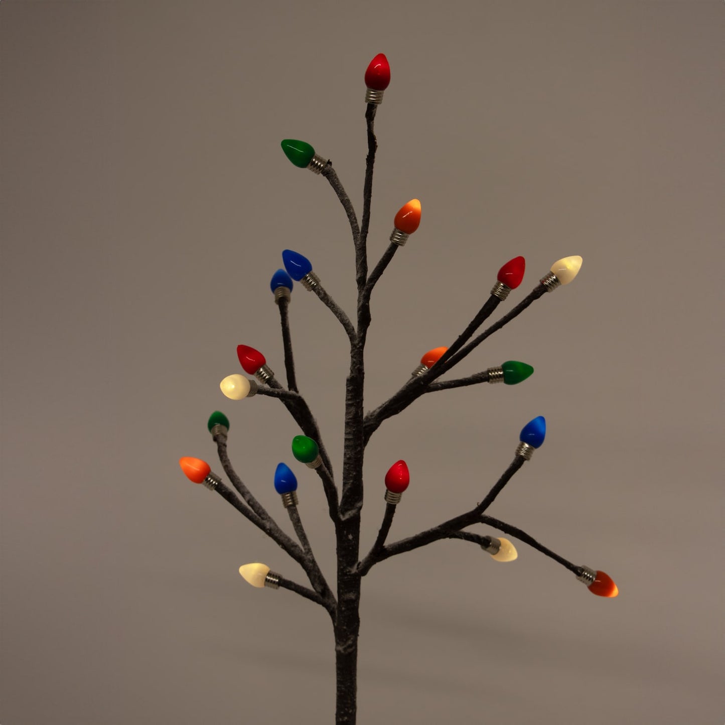Handcrafted lighted holiday tree featuring slender branches with colorful bulb caps in red, green, blue, orange, and white, perfect for Home & Decor, Holiday Decor, Best Sellers, and Promo Eligible collections.