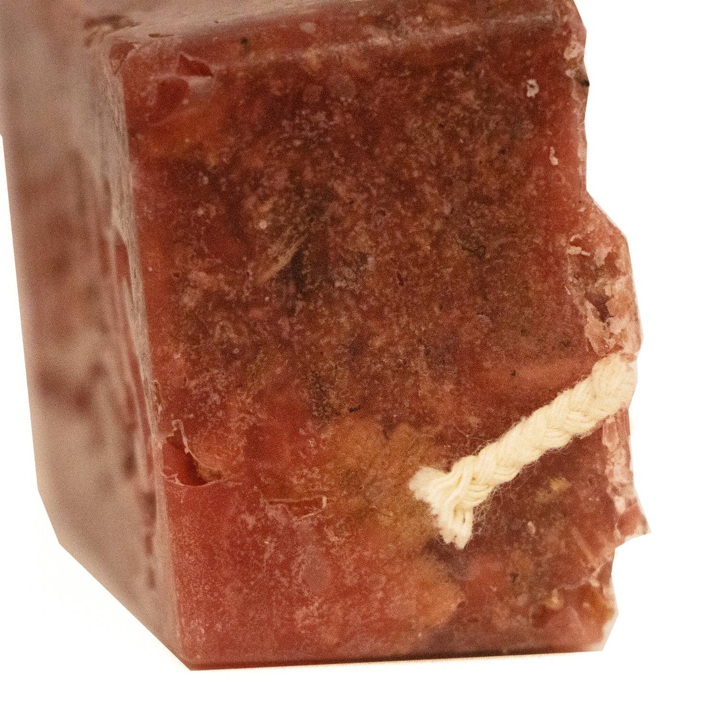 Close-up of a handcrafted reddish-brown fire starter block with a thick natural wick, ideal for wood-burning stoves, fireplaces, and campfires in Farm, Garden & Tool and Hearth Accessories collections.