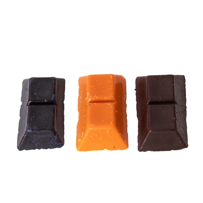 Three handcrafted soy wax dye chips in red, yellow, and dark brown colors, designed for use in candles and candlemaking, candlemaking supplies, and best sellers collections.