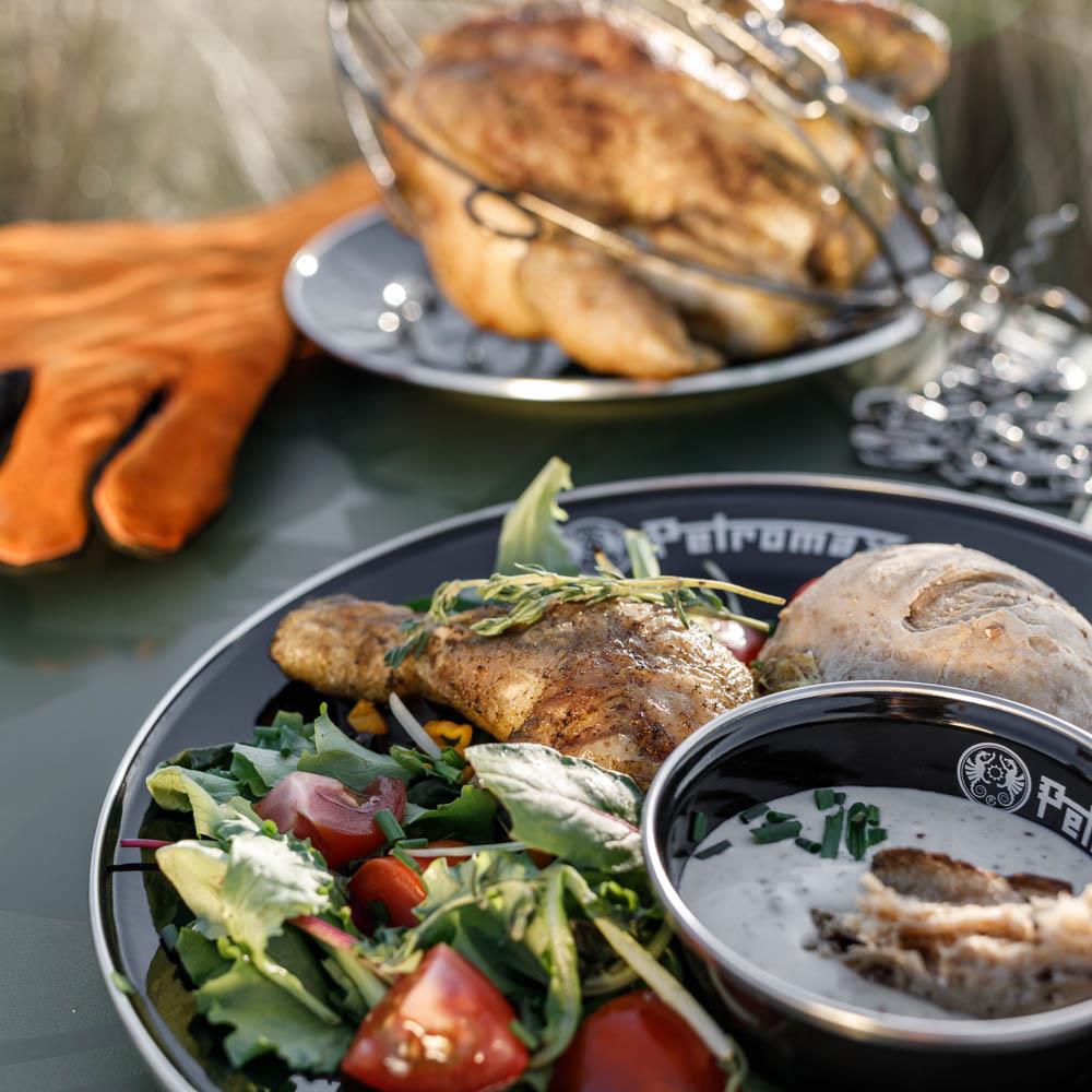 Black rimmed enamel plate and bowl with Petromax logo, featuring grilled chicken, fresh mixed salad, bread roll, and creamy dip, ideal for outdoor dining in Farm, Garden & Tool, Kitchen & Food, Camping, Dinnerware, Best Sellers, Promo Eligible collections.