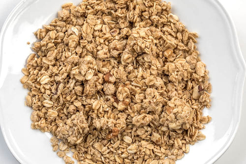 Close-up of wholesome Amish-made granola clusters featuring whole grain oats and nuts, a handmade, preservative-free snack from USA-made Kitchen & Food and Snacks collections.