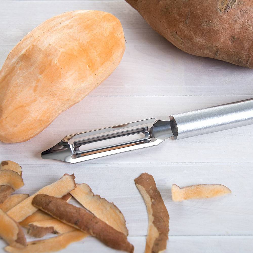 Handcrafted vegetable peeler with razor-sharp stainless steel blade and solid aluminum handle, peeling a sweet potato, made in USA for Kitchen & Food, Specialty Equipment, Peelers and Pitters, Best Sellers collections.