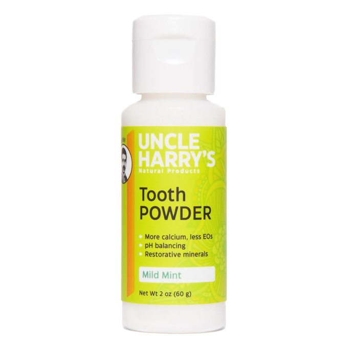 2 oz white plastic bottle of natural tooth powder with bright green label featuring mild mint flavor, pH balancing, restorative minerals, made in USA, ideal for Health & Wellness and Grooming collections.