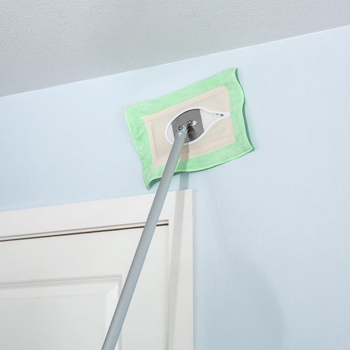 Light green microfiber replacement mop head attached to a long handle, gently cleaning a high wall surface; handcrafted and Amish made, ideal for household cleaning and home decor.