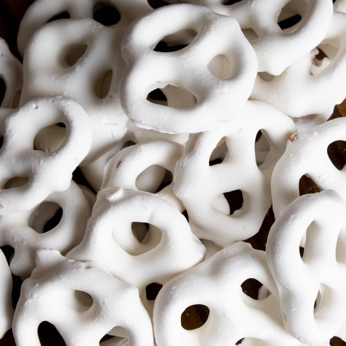 Close-up of handcrafted mini pretzels generously coated in white chocolate, a USA made snack perfect for Kitchen & Food, Food, Snacks and Sweets, Candy, Best Sellers, and Promo Eligible collections.