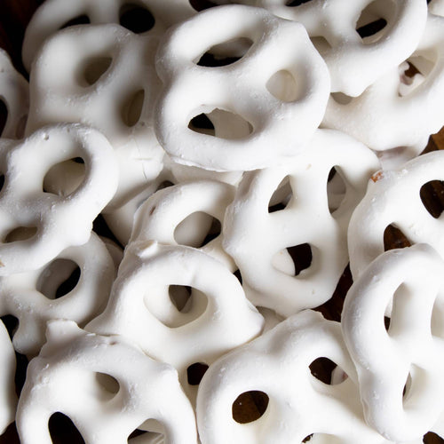 Close-up of handcrafted mini pretzels generously coated in white chocolate, a USA made snack perfect for Kitchen & Food, Food, Snacks and Sweets, Candy, Best Sellers, and Promo Eligible collections.