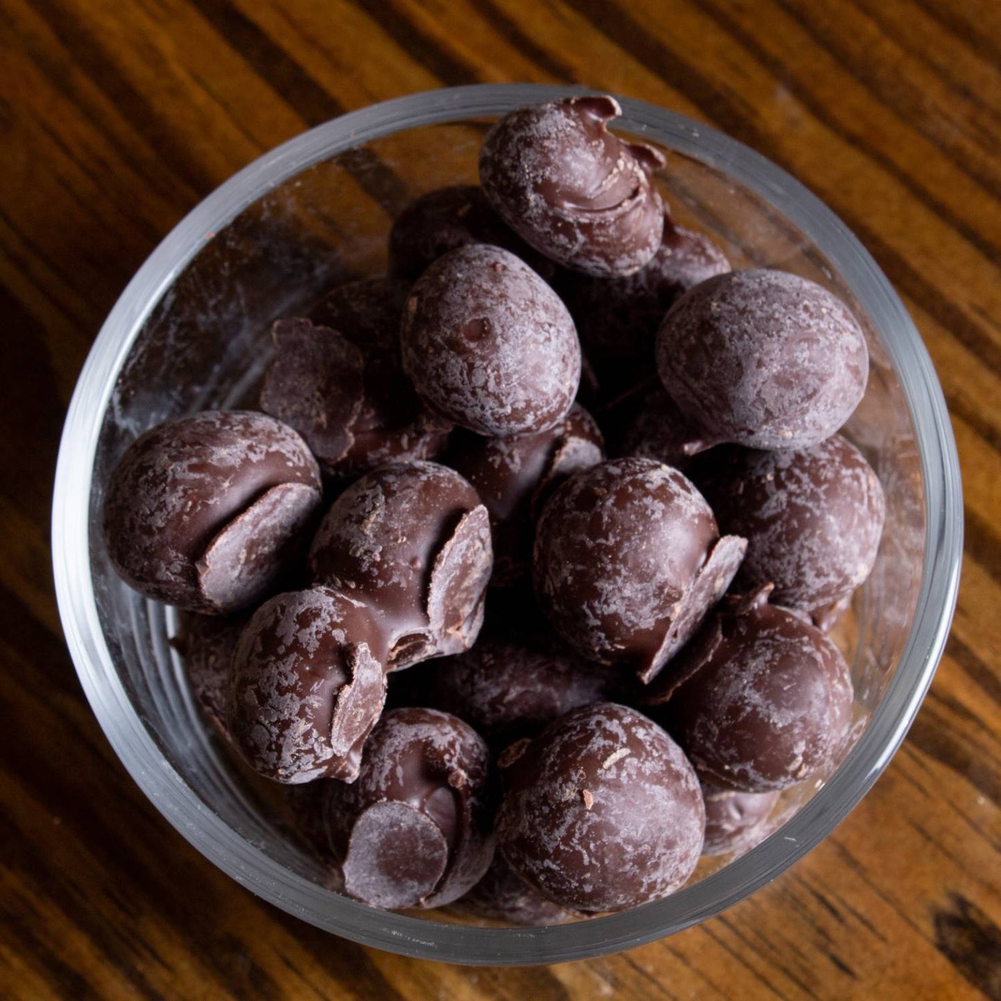 Clear glass bowl filled with handcrafted double-dipped chocolate peanuts made with fresh roasted nuts, a USA made snack perfect for Kitchen & Food, Snacks and Sweets, Candy, and Best Sellers collections.
