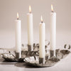 Set of four handcrafted white dripless candles with extra thick wicks burning brightly in metal candle holders, perfect for emergency supplies, lamps, and USA made collections.
