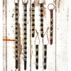 Assortment of handcrafted sleigh bell door hangers with brass and silver bells mounted on black and brown leather straps, ideal for holiday decor and USA made collections.