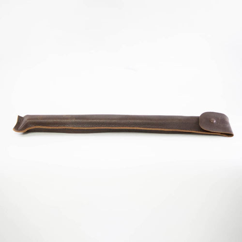 Handcrafted dark brown leather sheath with stitched edges and a button closure, designed to protect and carry woodcutting tools in farm, garden, and hauling collections.