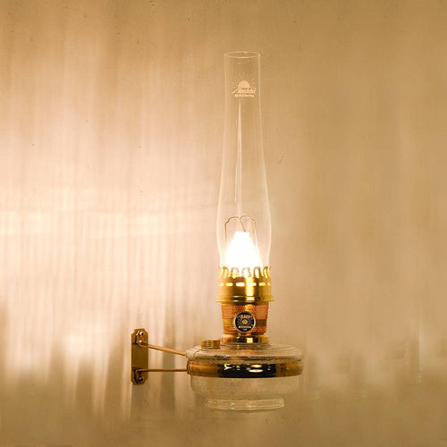 Handcrafted clear wall-mounted oil lamp with polished brass burner and tall glass chimney, designed for bright, space-saving lighting in Farm, Garden & Tool, Lamps & Lighting, Emergency Supplies, Oil Lamps, Wall Lamps, and Best Sellers collections.