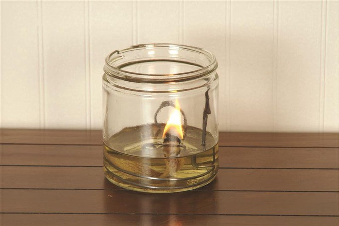 Handcrafted olive oil lamp with a flat wick burning brightly in a clear glass jar, ideal for Lamps & Lighting, USA Made, and Olive Oil Lamps collections.