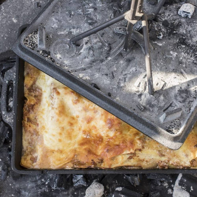 Cast iron loaf pan with well-browned casserole cooking over hot coals, ideal for Farm, Garden & Tool, Kitchen & Food, Camping, Cookware, Cast Iron, Best Sellers, and Bread Making Supplies collections.