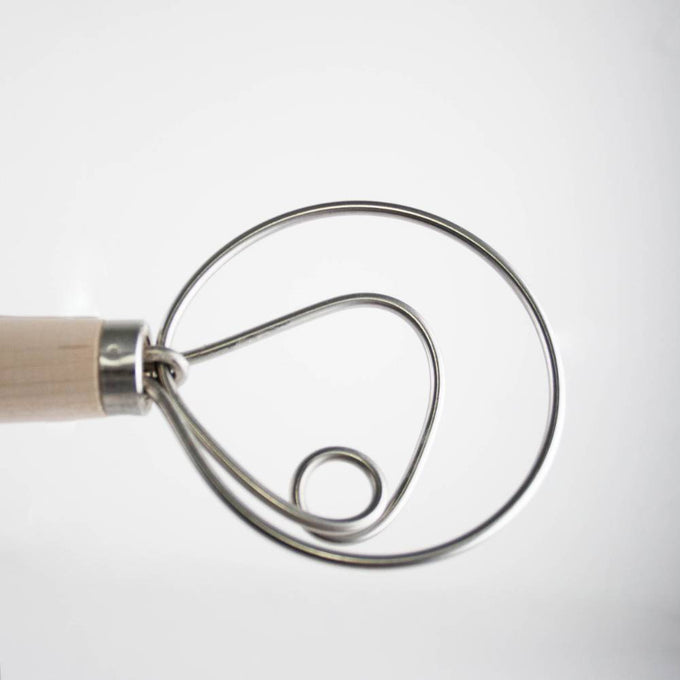 Close-up of a handcrafted Amish made dough whisk with a wooden handle and smooth spiral metal wires, ideal for mixing dough in Kitchen & Food and Baking Supplies collections.