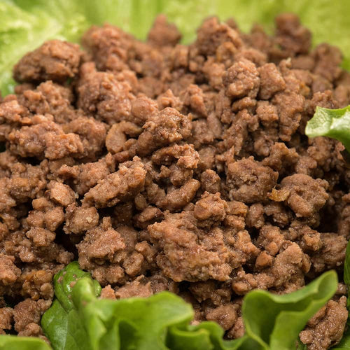 Close-up of cooked canned ground beef served on fresh green lettuce, highlighting its ready-to-use quality, ideal for Kitchen & Food, Meats, Best Sellers, and Promo Eligible collections.
