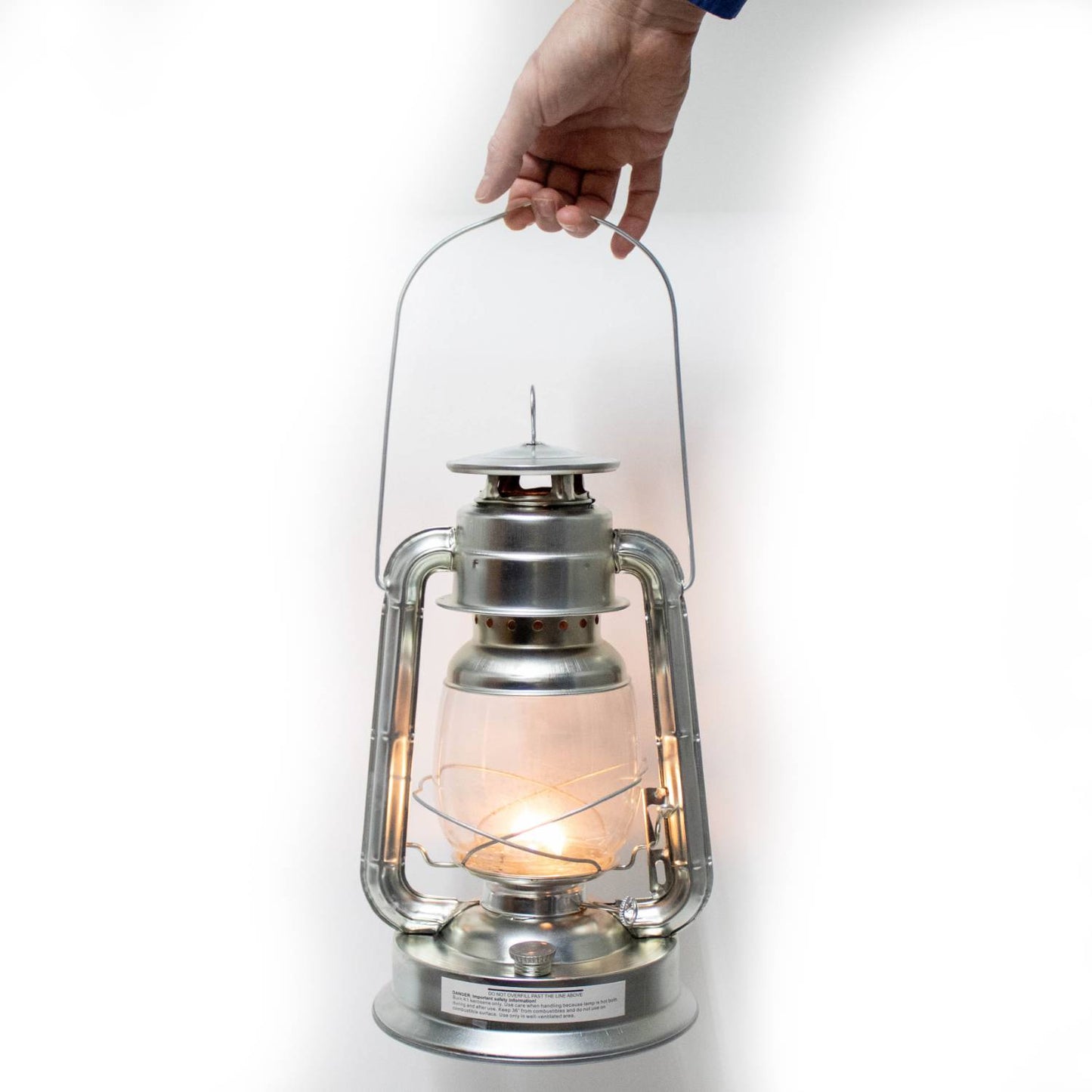 Hand holding a handcrafted silver lantern with a lit flame inside, designed for reliable use in Farm, Garden & Tool, Camping, Emergency Supplies, and Lamps & Lighting collections.