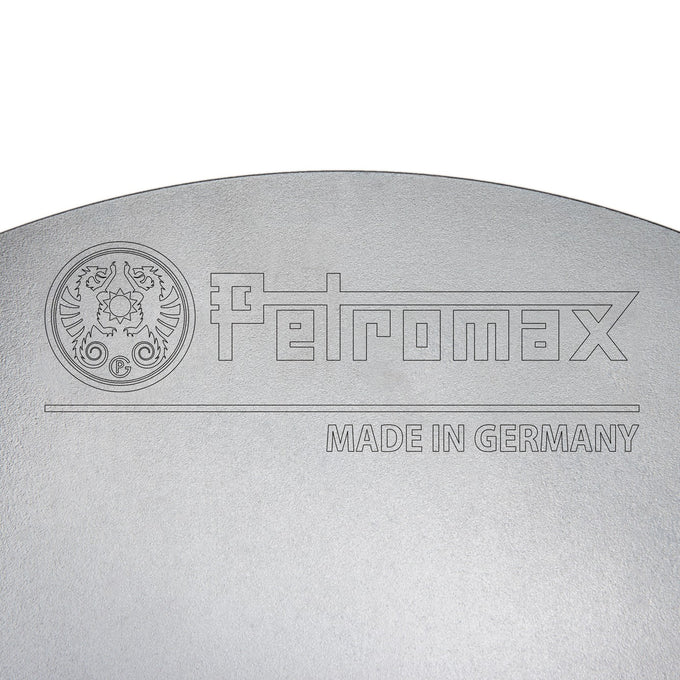 Close-up of a high-quality steel cooking surface engraved with a detailed logo and "Made in Germany," highlighting durable craftsmanship for Farm, Garden & Tool, Camping, Best Sellers, Promo Eligible collections.