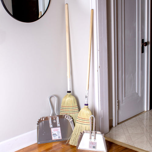 Set of lightweight rustproof aluminum dustpans with stays-flat design, hanging loops, and reinforced edges, paired with traditional straw brooms, perfect for household cleaning and Home & Decor use.