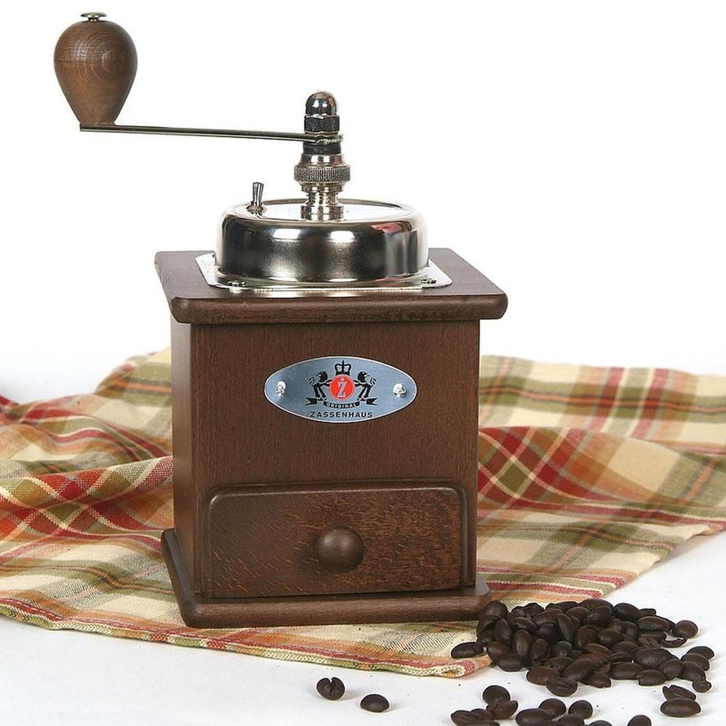 Handcrafted wooden coffee mill with metal crank handle and shiny grinding mechanism, displayed on a plaid cloth with coffee beans, ideal for Farm, Garden & Tool and Brewing Coffee and Tea collections.