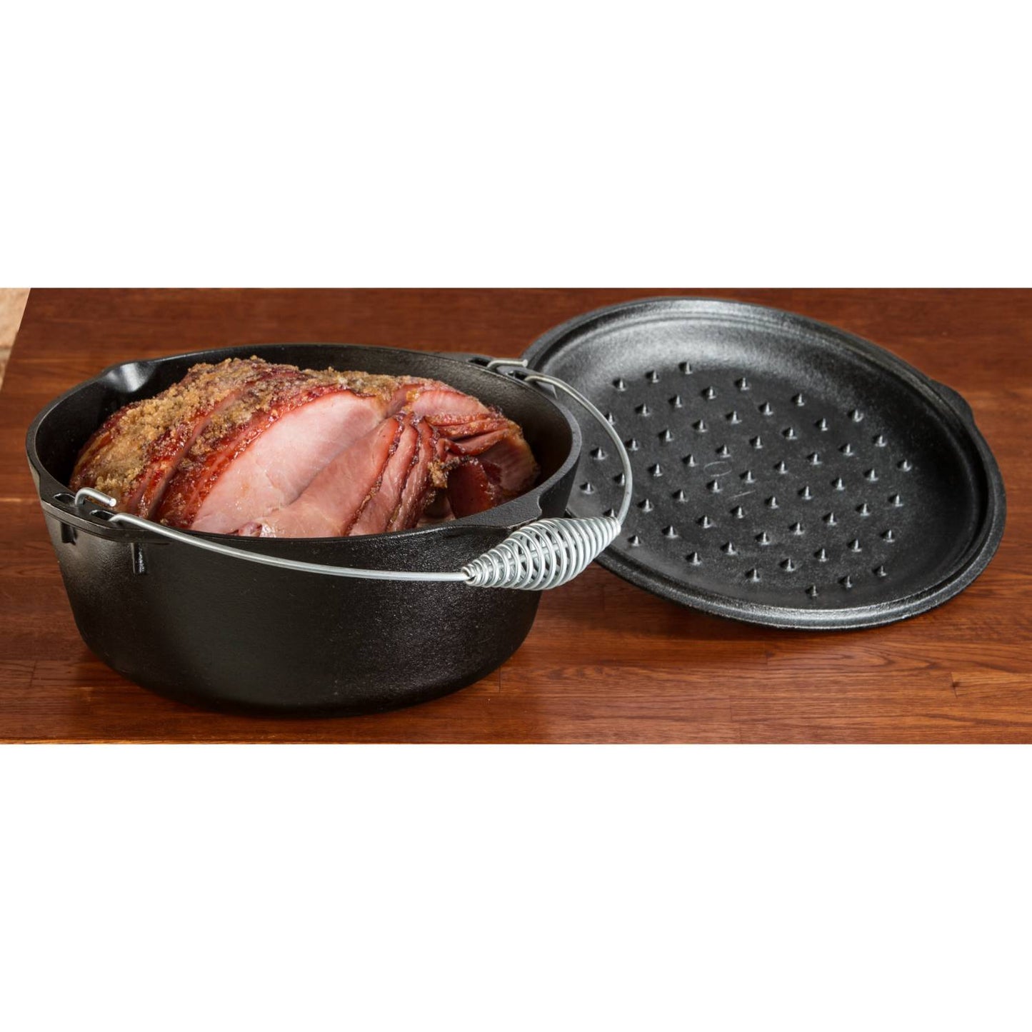 Black cast iron Dutch oven with spiral bail handle and self-basting lid featuring nubs, holding sliced roast, crafted in USA, perfect for Kitchen & Food, Cookware, Cast Iron, Best Sellers collections.