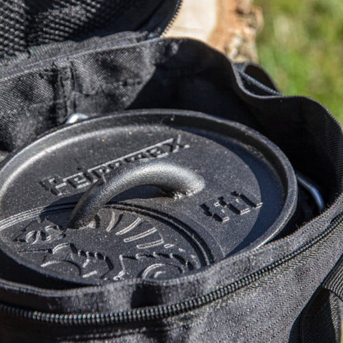 Close-up of a cast iron Dutch oven inside a black durable transport bag with zipper and padded interior, ideal for Farm, Garden & Tool, Camping, and Best Sellers collections.