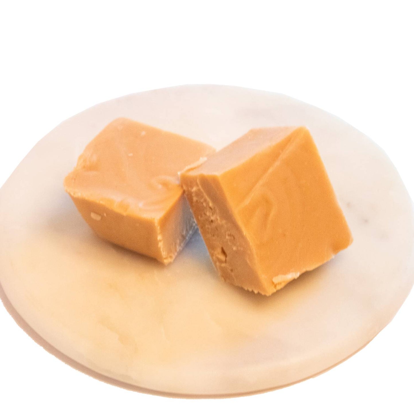 Two handcrafted creamy caramel-colored fudge pieces with a smooth texture on a white marble plate, featured in Kitchen & Food, Snacks and Sweets, USA Made, and Best Sellers collections.