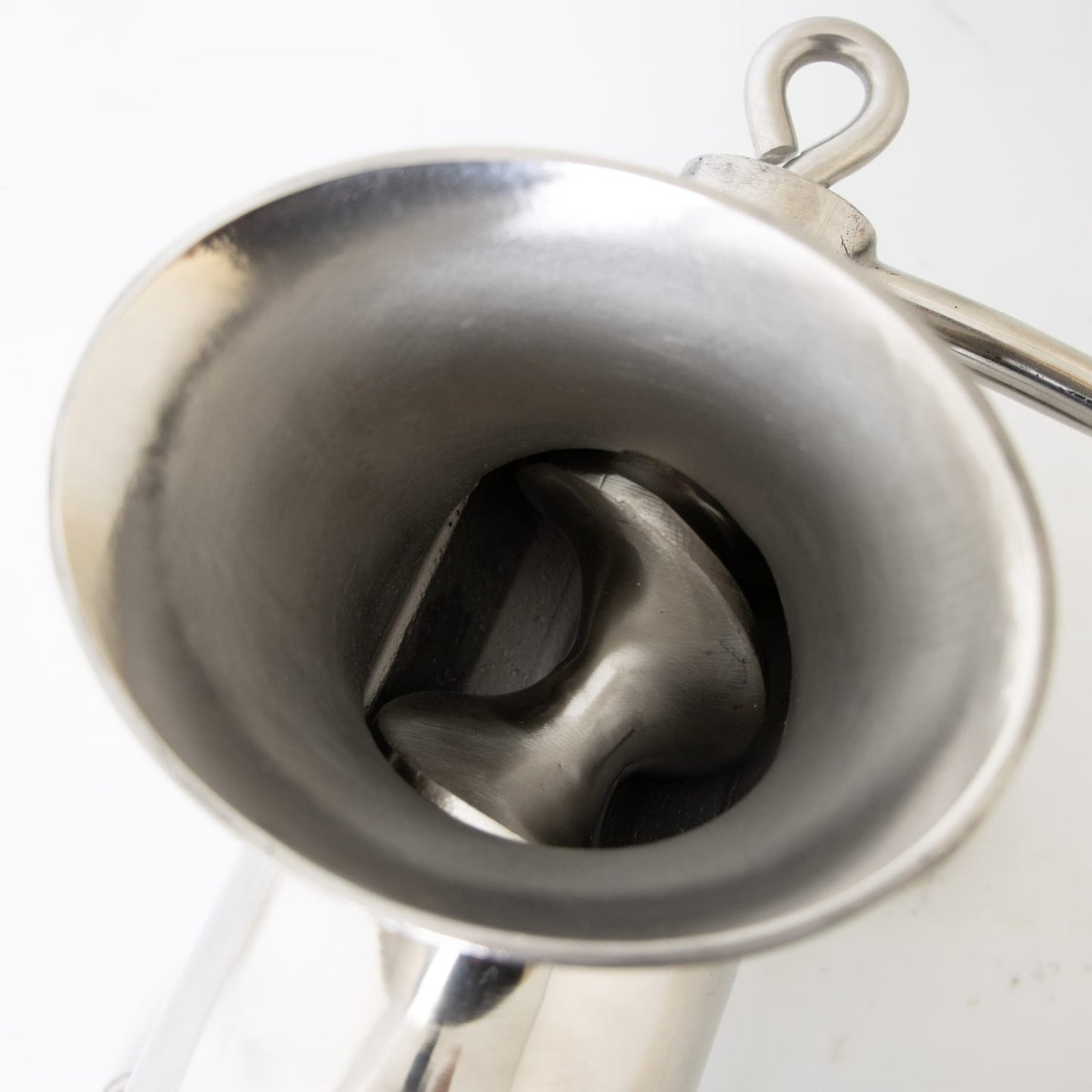 Close-up view inside the polished stainless steel mounted meat grinder showing the spiral auger and wide hopper, handcrafted and featured in Kitchen & Food, Specialty Equipment, and Butchering Supplies collections.