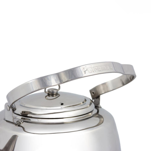Close-up of the bent stainless steel handle with embossed logo on a polished teakettle lid, designed for comfortable hanging and use in Farm, Garden & Tool, Camping, and Brewing Coffee and Tea collections.