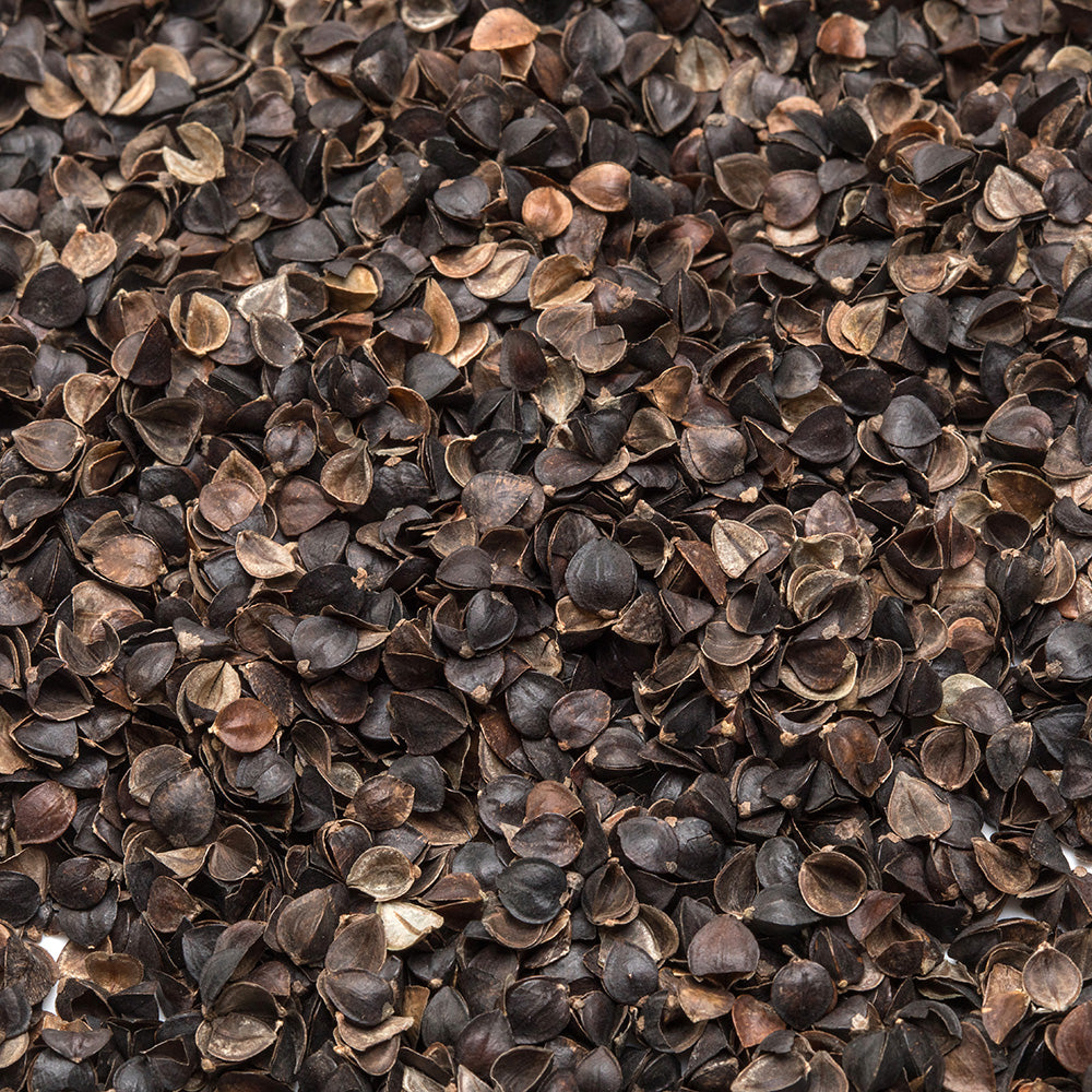 Close-up of natural dark brown buckwheat hulls with varied earthy tones and textured surfaces, used as adjustable filling for handcrafted buckwheat bed pillows in Home & Decor and USA Made collections.