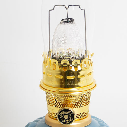 Close-up of a handcrafted limited edition oil lamp burner with polished brass elements and clear textured chimney, featured in Lamps & Lighting, Oil Lamps, Table Lamps, Best Sellers, and Promo Eligible collections.