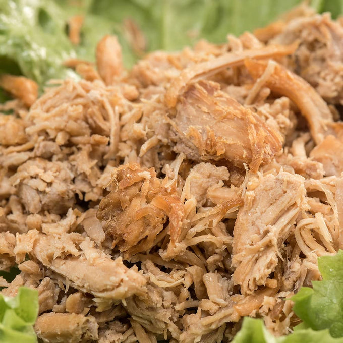 Close-up of Amish-made shredded pork with a tender texture served on fresh green lettuce, ideal for Farm, Garden & Tool, Kitchen & Food, Emergency Supplies, Food, Meats, Best Sellers, and Promo Eligible collections.