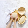 Handcrafted rattan proofing baskets with removable cloth liner shown with dough resting on a wooden board and white kitchen towel, ideal for Kitchen & Food, Baking Supplies, and Bread Making collections.
