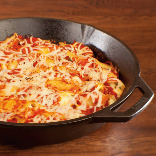 Pre-seasoned cast iron skillet filled with baked pasta topped with melted cheese, showcasing unmatched heat retention and durability in Kitchen & Food, Cookware, Cast Iron, Best Sellers, and Promo Eligible collections.