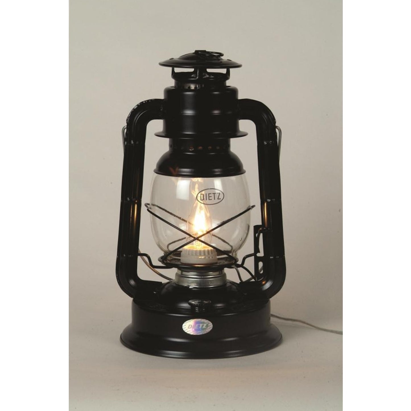 Classic black lantern converted to electric light with visible filament bulb, featuring glass globe and sturdy metal frame, ideal for lamps and lighting collections.
