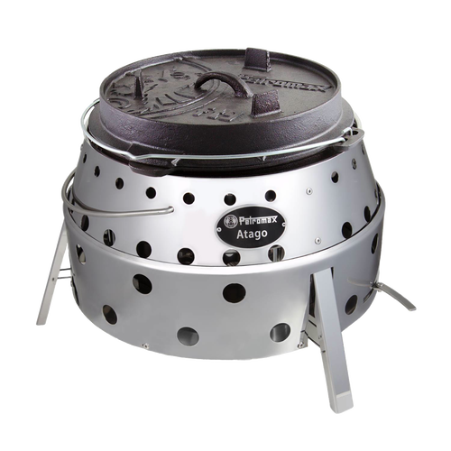 Portable stainless steel camp grill and fire bowl with round perforated body and cast iron lid, handcrafted for outdoor grilling, camping, and firepit use.