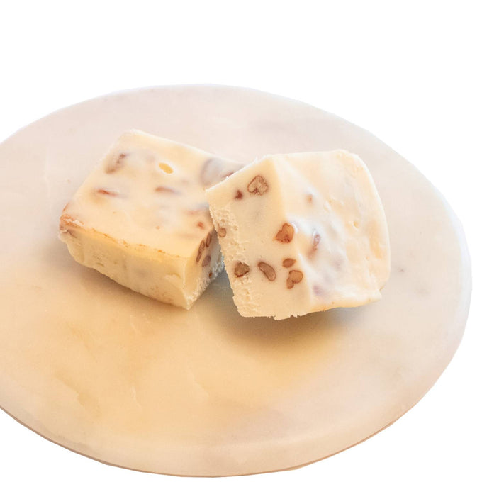 Two handcrafted creamy white fudge pieces with embedded nut pieces, featuring a rich, smooth texture, from Kitchen & Food, Food, Snacks and Sweets, USA Made, Best Sellers, Promo Eligible collections.