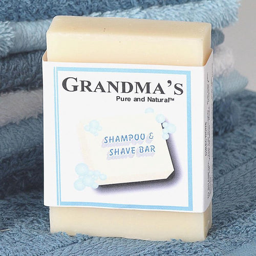 Handcrafted natural shampoo and shave bar soap resting on folded blue towels, highlighting gentle, chemical-free ingredients for grooming and personal hygiene in Health & Wellness and USA Made collections.