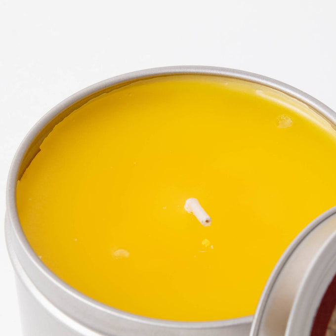 Hand-poured Amish-made bright yellow citronella candle with a single wick in a lightweight silver tin, perfect for outdoor use in camping, pest control, and garden lighting collections.
