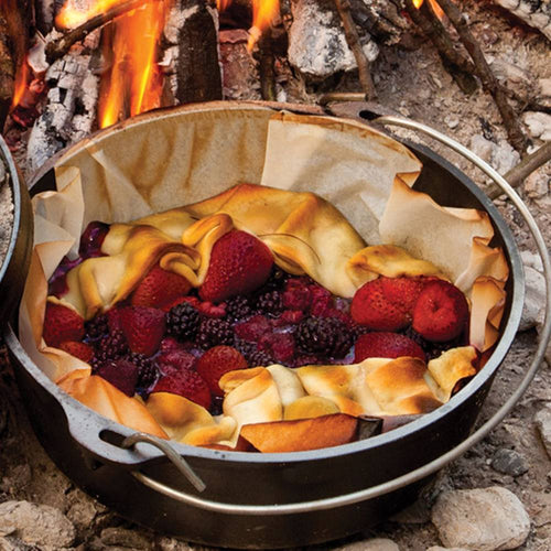 Handcrafted cast iron camp Dutch oven baking mixed berry pie with golden crust over an open fire, featured in Farm, Garden & Tool, Camping, Cast Iron, USA Made, Best Sellers, and Promo Eligible collections.