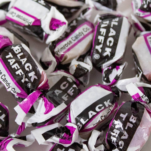 Individually wrapped black taffy candies with distinctive purple and white packaging, evoking classic sweet flavors, featured in Kitchen & Food, Snacks and Sweets, Best Sellers, and Promo Eligible collections.