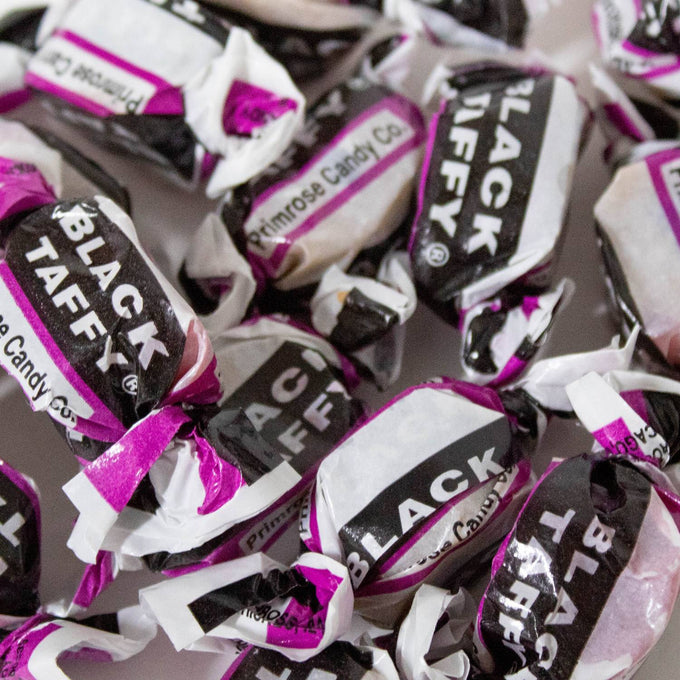 Individually wrapped black taffy candies with distinctive purple and white packaging, evoking classic sweet flavors, featured in Kitchen & Food, Snacks and Sweets, Best Sellers, and Promo Eligible collections.