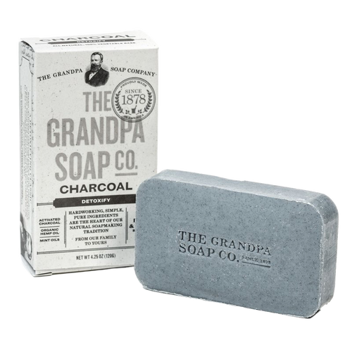 Handcrafted charcoal soap bar embossed with brand name next to vintage-style box packaging, featuring natural detoxifying ingredients, part of Health & Wellness, Soaps, Grooming, USA Made, Best Sellers, and Promo Eligible collections.