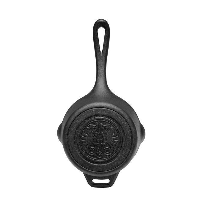 Heavy-duty cast iron saucepan with self-basting lid, featuring embossed design on bottom and extended handle, ideal for camping, farm, garden, and outdoor cooking.